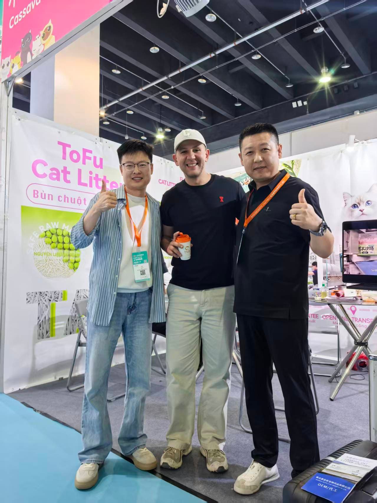 RootPurr team and partners at the international pet expo, in front of the Cassava Cat Litter brand panels.